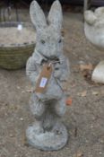 A reconstituted stone garden ornament modelled as a rabbit.