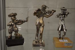 Frank Meisler, a model of a musician together with two silver overlaid models of musicians.