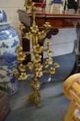 An ornate gilded brass naturalistic form floor standing candelabra.