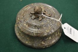 A serpentine paperweight.