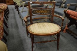 An inlaid mahogany elbow chair.