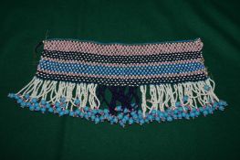 A bead work choker or collar (?).