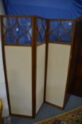 A mahogany framed glazed and upholstered dressing screen.