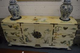 A cream painted and chinoiserie decorated Chinese style sideboard.