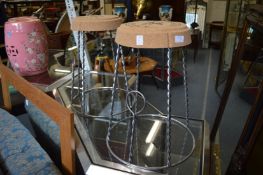 A pair of novelty bar stools modelled as the tops of Champagne bottles.