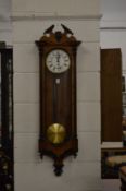 A walnut cased Vienna style wall clock.
