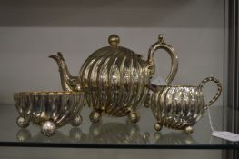 A plated three piece tea service of bulbous wrythen design.