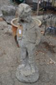A weathered reconstituted stone garden ornament modelled as a young boy.