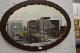 A mahogany oval mirror.