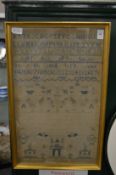 A framed and glazed sampler dated 1843.