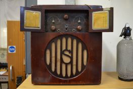An early battery operated radio with mahogany stained cabinet.