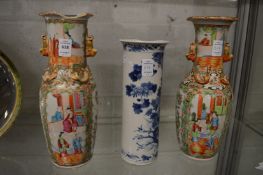 A pair of Chinese famille rose vases and a blue and white sleeve vase (faults).