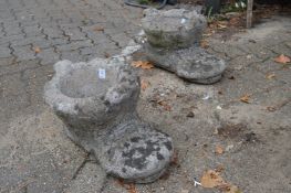 A pair of garden planters modelled as old boots.