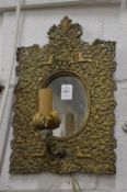 An ornate brass girandole.