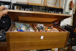 A sewing box with contents together with a sewing machine.