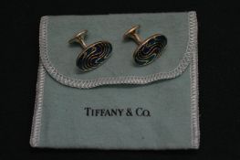 A pair of Tiffany & Co silver and enamel cufflinks.