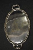 A large twin handled plated tray.
