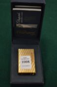 A Dupont gilt metal cigarette lighter with original case and paperwork.