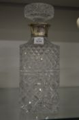 A silver mounted cut glass whiskey decanter.