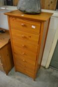 A pine narrow seven drawer chest.