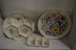 Two Poole pottery hors-d'oeuvre dishes and a Poole pottery plate.
