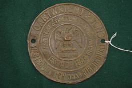 An embossed brass name plate from a Victorian safe.