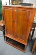A mahogany two door storage cabinet.