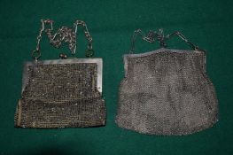 A silver chain mail evening purse and a plated evening purse.