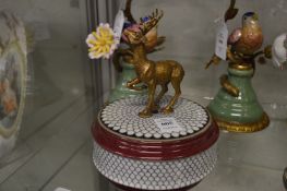 A porcelain circular box and cover mounted with a deer.