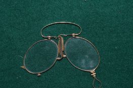 A pair of gold spectacles.