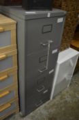 A metal four drawer filing cabinet.