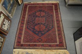 A small Persian style rug, 150cm x 110cm.