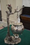 An unusual brandy warmer of naturalistic form modelled as an owl perched on a tree, a cauldron