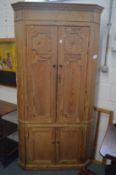 A 19th century pine standing four door corner cupboard.