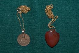 Two decorative pendants and chains.