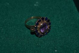 An 18ct gold sapphire and amethyst ring.