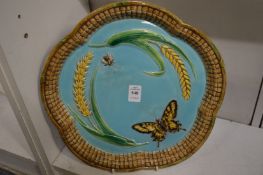 A George Jones majolica dish decorated with butterfly, insect and corn.