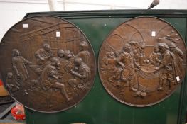 Two large circular embossed copper plaques.