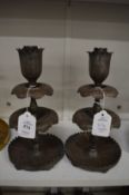 A good pair of Islamic tinned copper candlesticks with chased decoration.