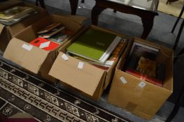 Four boxes of assorted books.