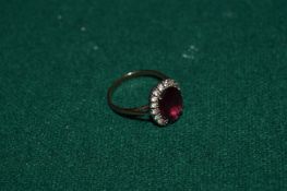 A yellow metal and gem set ring.