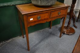 An oak two drawer side table.