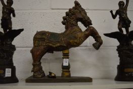 An Indian carved hardwood horse with painted decoration.