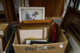 A box of various paintings and prints.