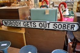 A novelty carved wooden painted sign.