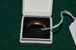 A 22ct gold wedding band.