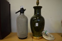 A table lamp and a soda siphon.