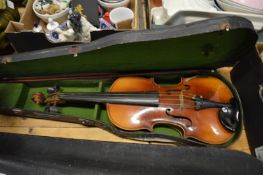 A cased violin and bow.