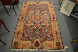 An unusual Persian rug with floral decoration, 205cm x 125cm.