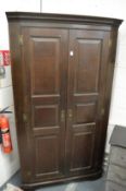 A 19th century oak standing two door corner cupboard.